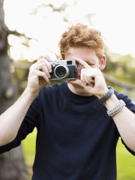 Portrait of young man taking photos