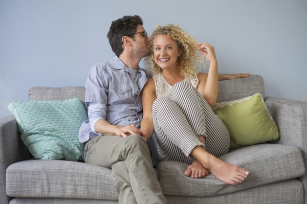 Couple sitting on sofa.