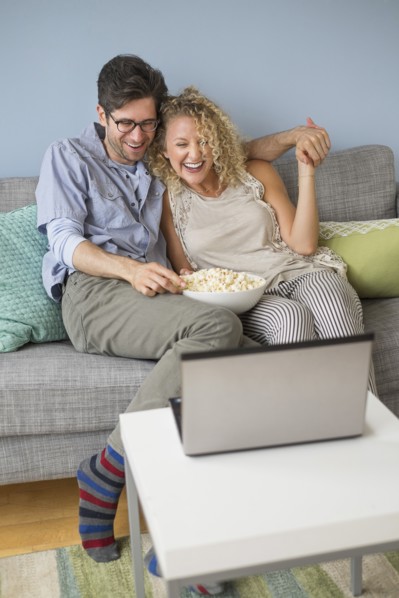 Couple watching movies on laptop.