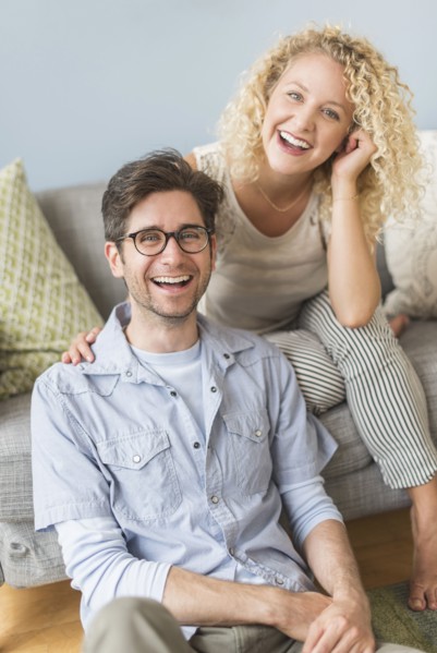 Portrait of couple in living room.