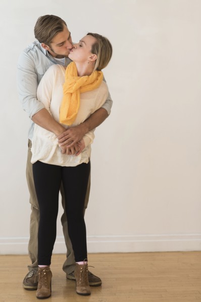 Young couple embracing and kissing.