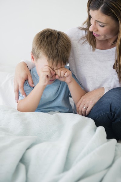 Mother consolling son (6-7)