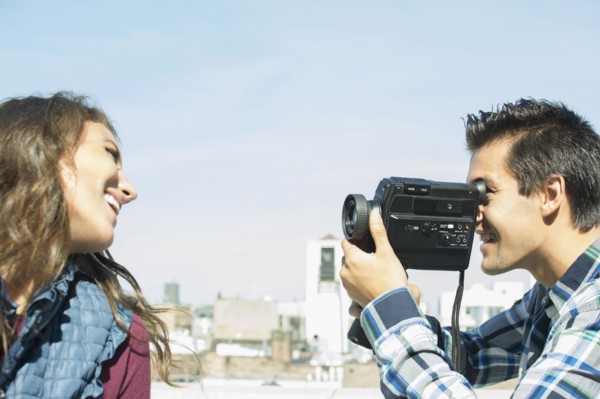 Man filming his girlfriend on roof