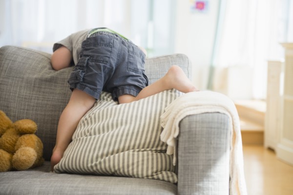 Boy (2-3) playing on sofa