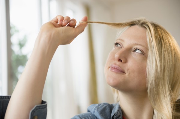 Woman twisting her hair