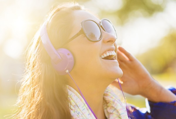 Woman in sunglasses and headphones outdoors