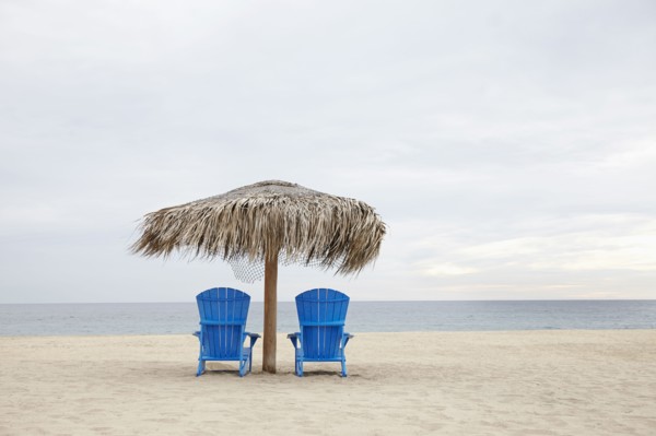 View of deckchairs on beach