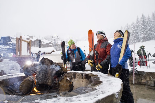 Group of friends with bonfire in winter