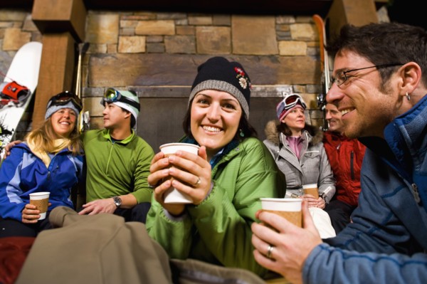 Group of skiers hanging out at fireplace