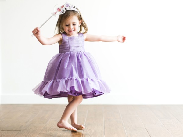 Girl (4-5) in princess costume dancing