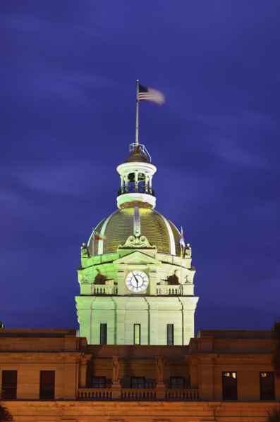 City hall clock tower illuminated in green
