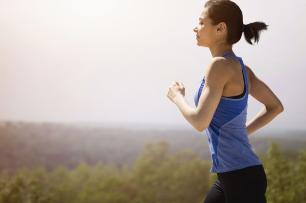 Young woman running outdoors.