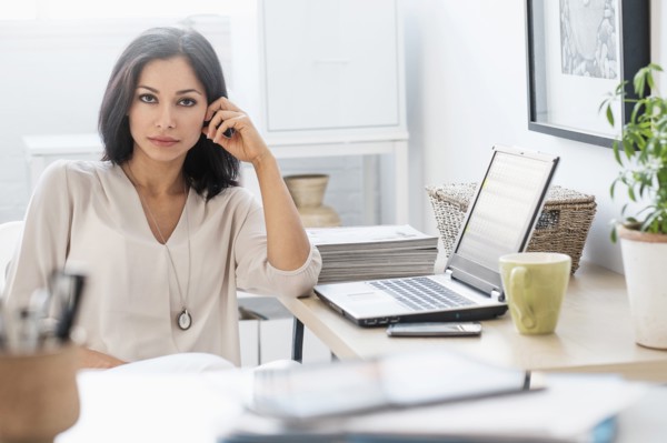 Woman sitting at desk with laptop.