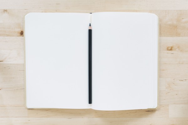 Overhead view of pencil in notebook