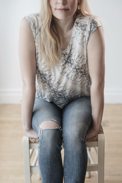 Low-section of woman wearing torn jeans.