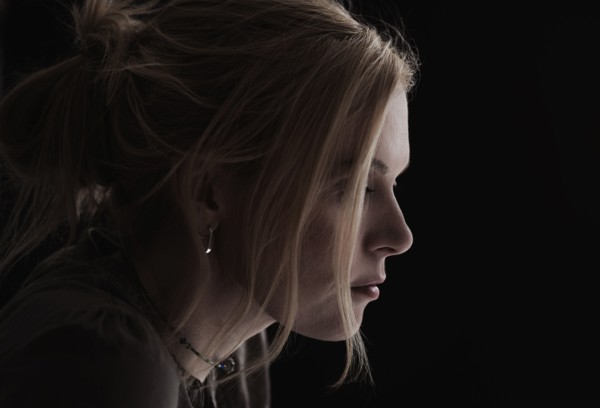 Portrait of blond woman in studio.