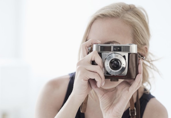 Woman taking photo with digital camera.
