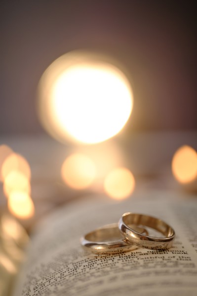 Wedding rings in open Bible.