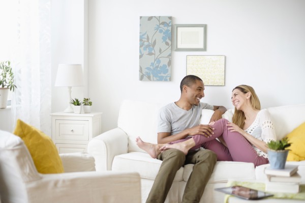 Mid adult couple relaxing in living room.