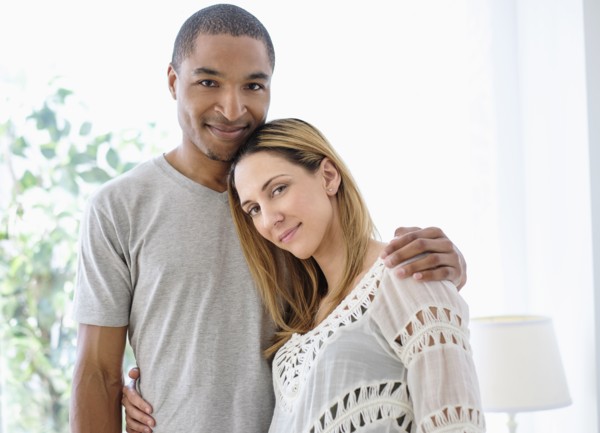 Mid adult couple embracing.