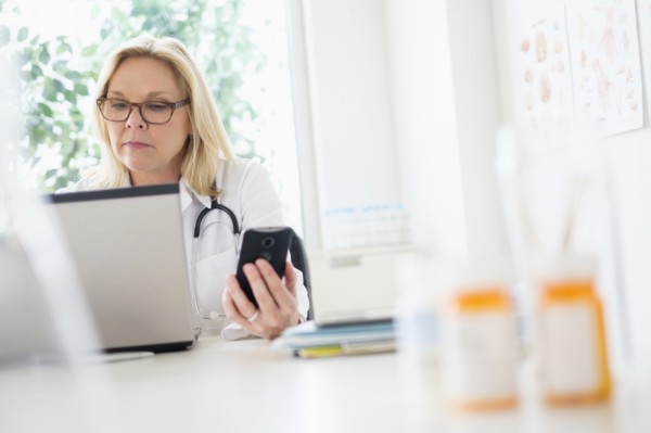 Doctor working with laptop in her office.