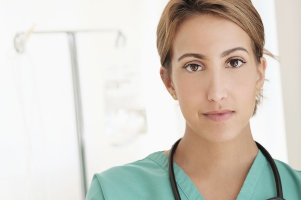 Young female doctor in hospital corridor.