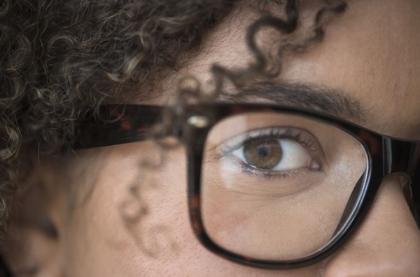 Close up of young woman in nerdy glasses.