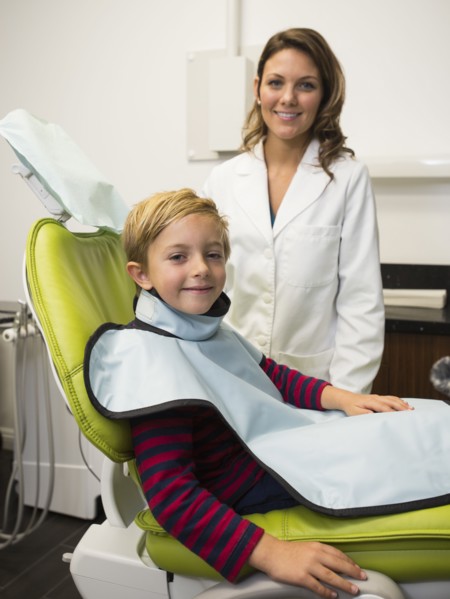 Dentist and patient (8-9) in dentist's office
