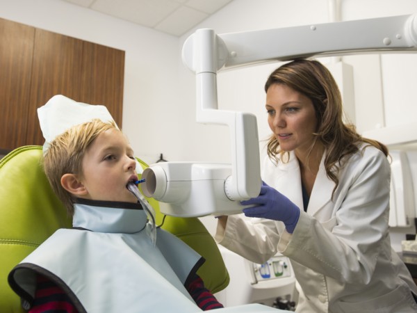 Dentist and patient (8-9) in dentist's office