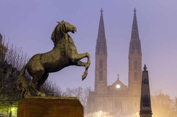 Horse sculpture of Waterloo Memorial and St. Boniface Church in mist