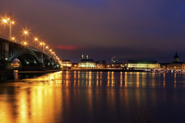 Illuminated Theodor Heuss Bridge and waterfront skyline
