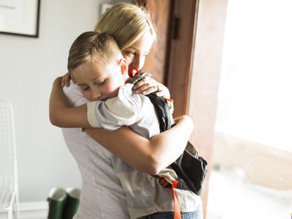 Mother hugging son (6-7)