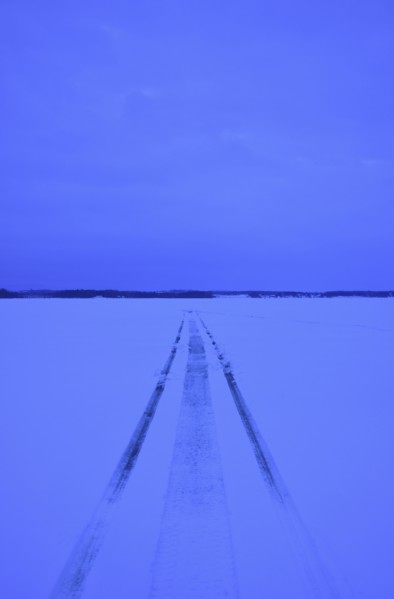 Snowmobile tracks on frozen lake