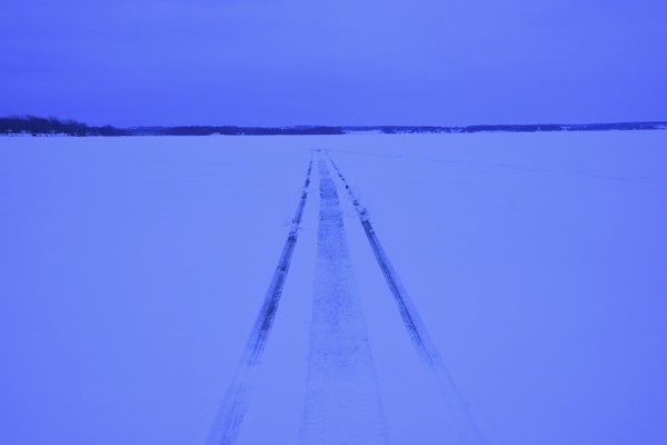 Snowmobile tracks on frozen lake