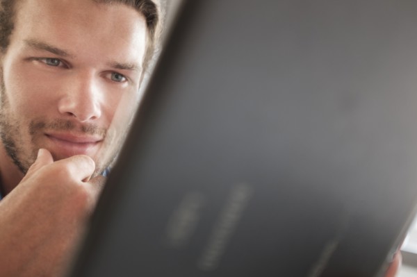 Mid-adult man using tablet pc.