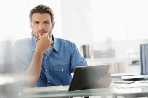 Portrait of mid-adult businessman working in office.