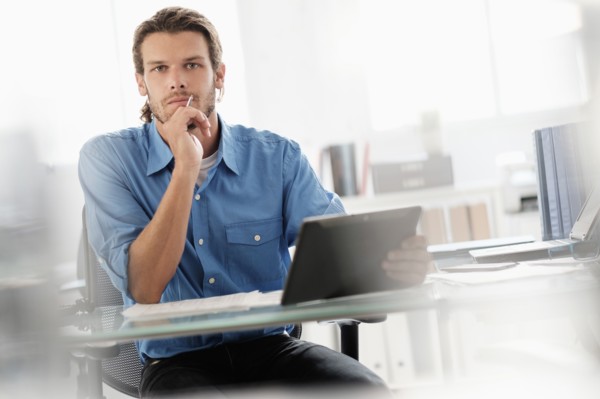 Portrait of mid-adult businessman working in office.