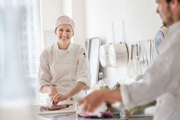 Chefs working in kitchen.