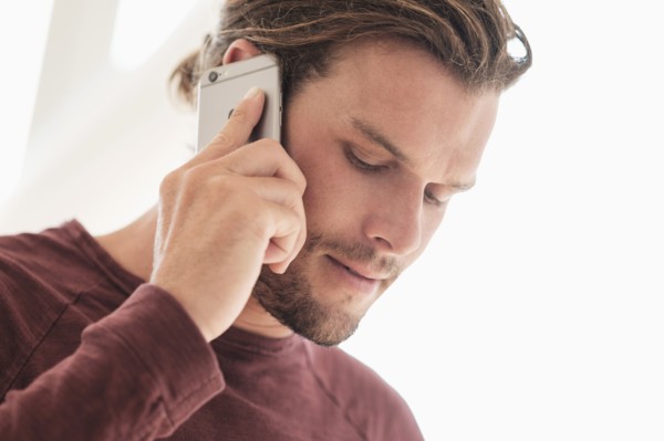 Mid-adult man talking on phone.