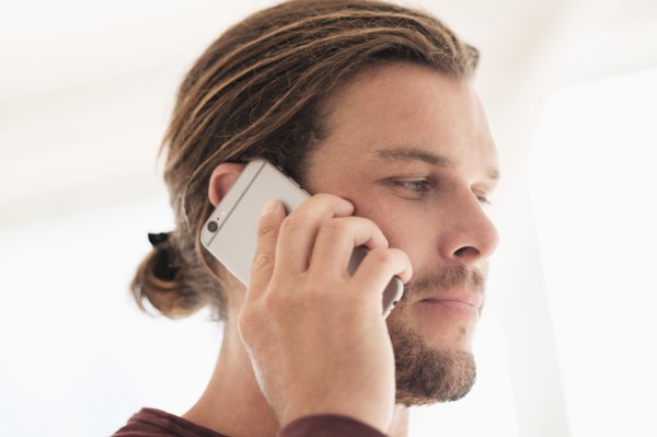 Mid-adult man talking on phone.