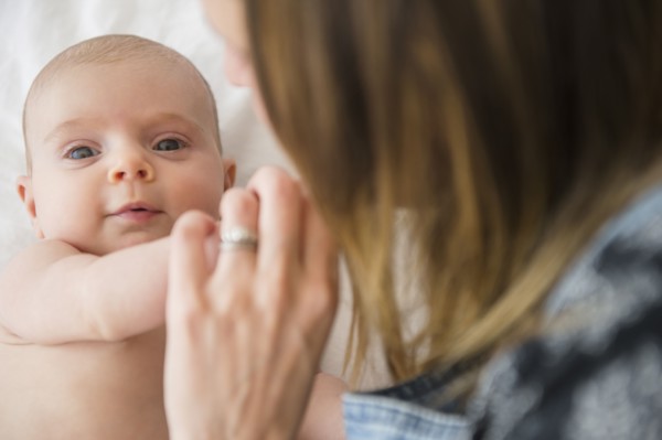 Mother consoling baby girl (2-5 months)