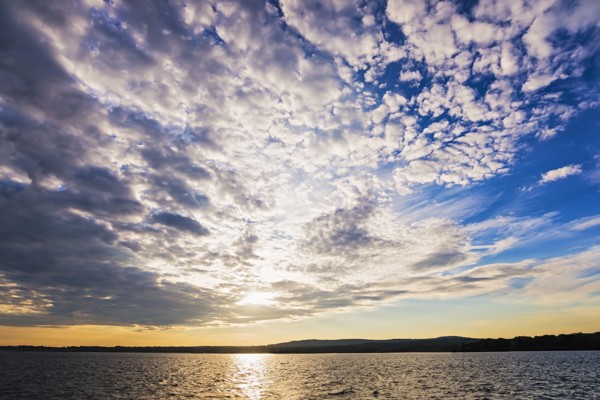 Cloudy sky above bay at sunset