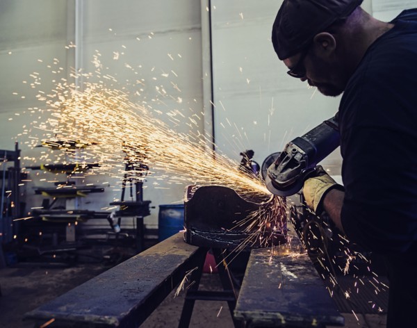 Welder working in metal workshop