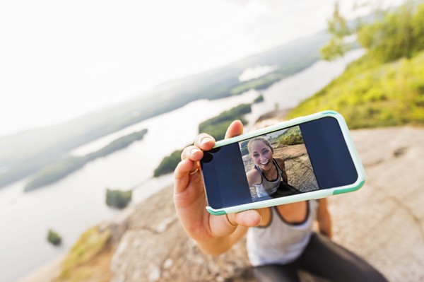 Young woman taking selfie on Smartphone