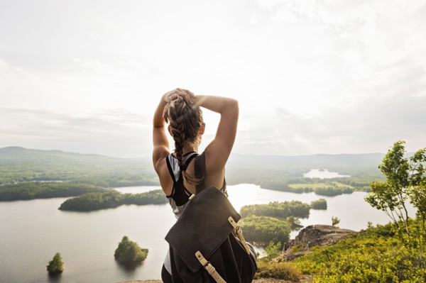 Rear view of young woman looking at lake