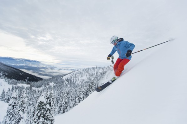 Mature man speeding on ski slope