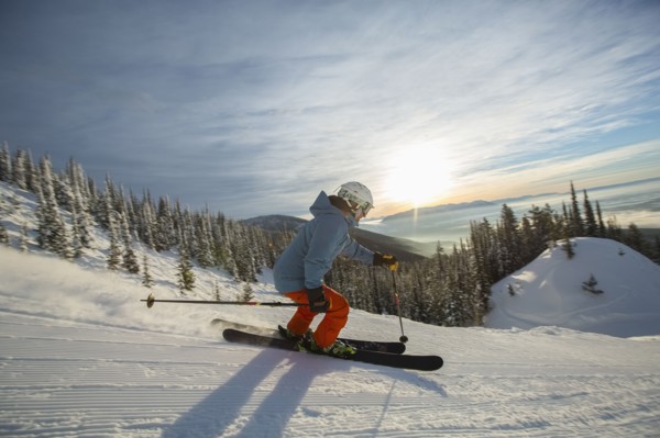 Mature man on ski slope at sunset