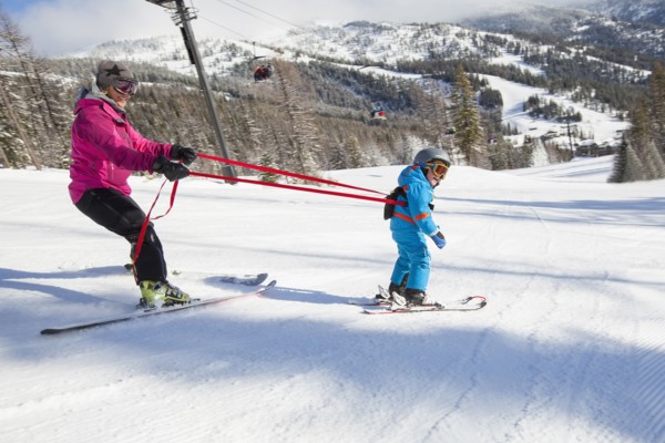 Mother teaching son (4-5) how to ski