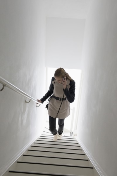 Woman walking up stairs and talking on phone