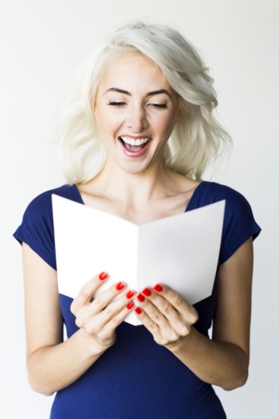 Studio shot of woman holding paper
